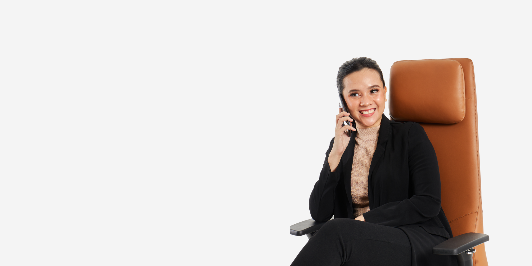 Smiling professional seated on a luxurious leather executive chair, showcasing a premium office chair designed for comfort and style in professional settings.