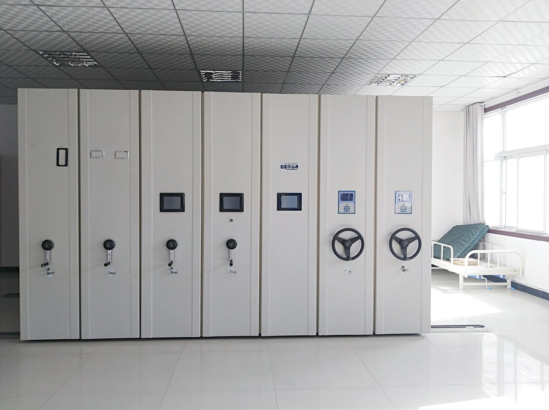 series of movable metal cabinets and mobile compactors in matte white finish in a storage room in the Philippines