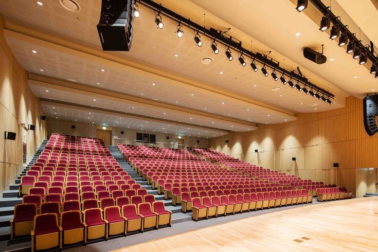 concert hall chairs in red fabric and wood finish