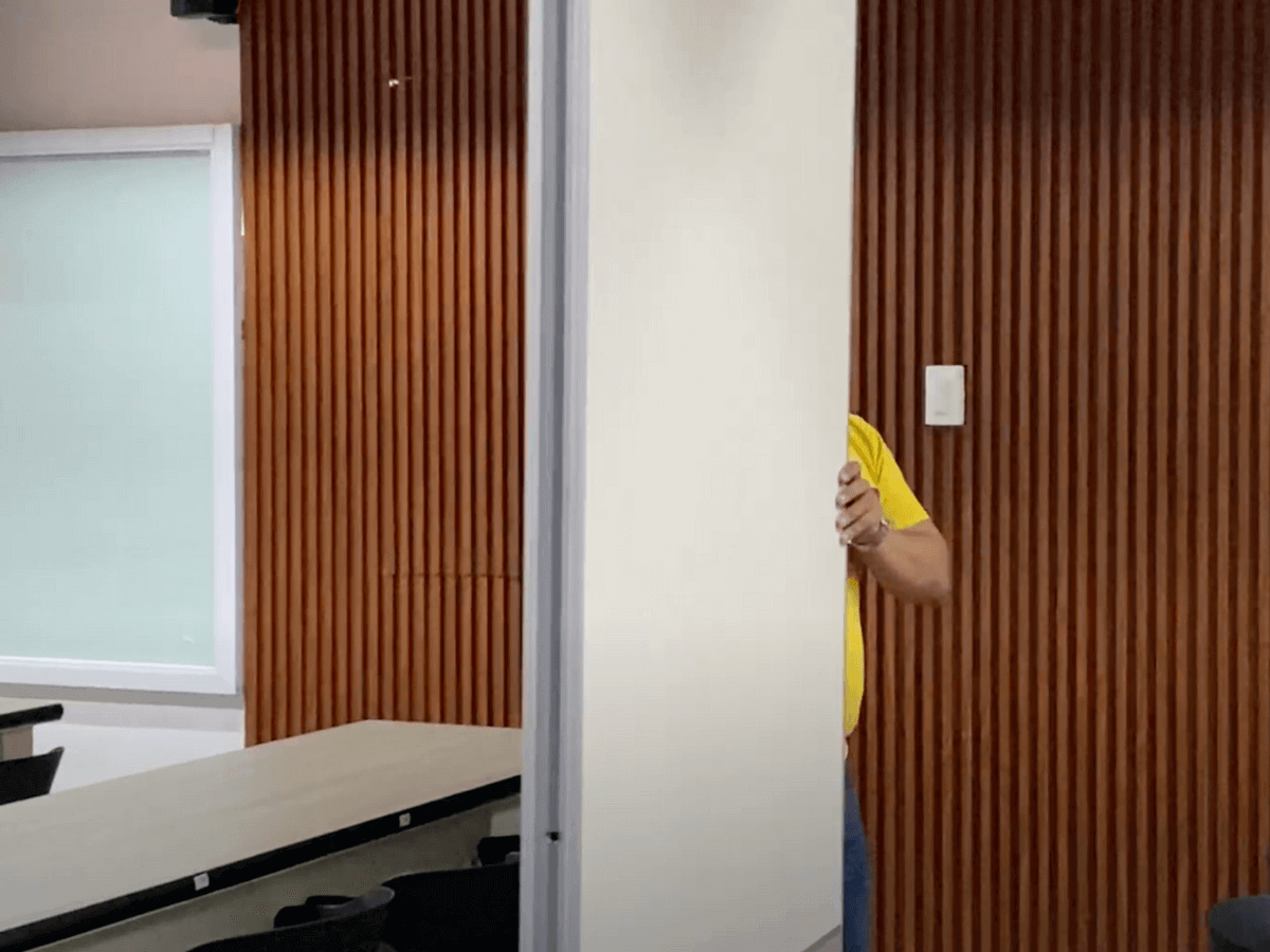 A man pushing an acoustic panel of an operable partition wall system in Manila, Philippines